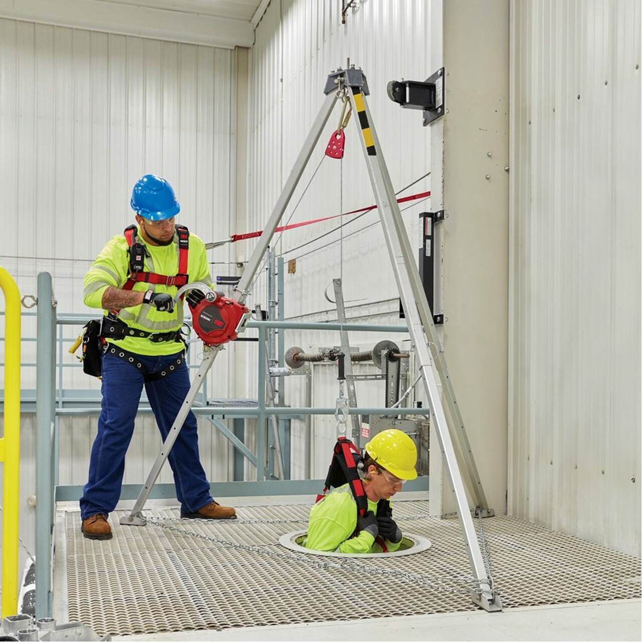 Rescue team using tripod system for confined space operation